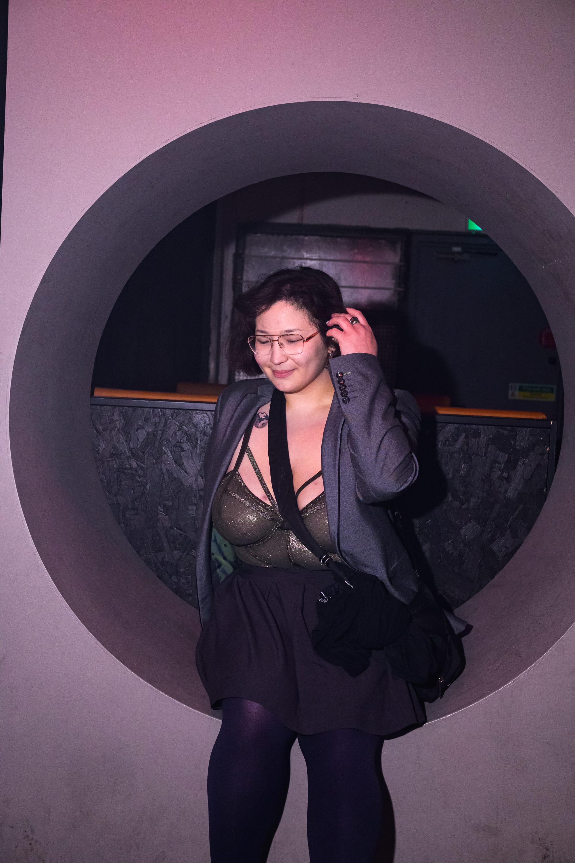 A really hot person sitting in a circular niche.