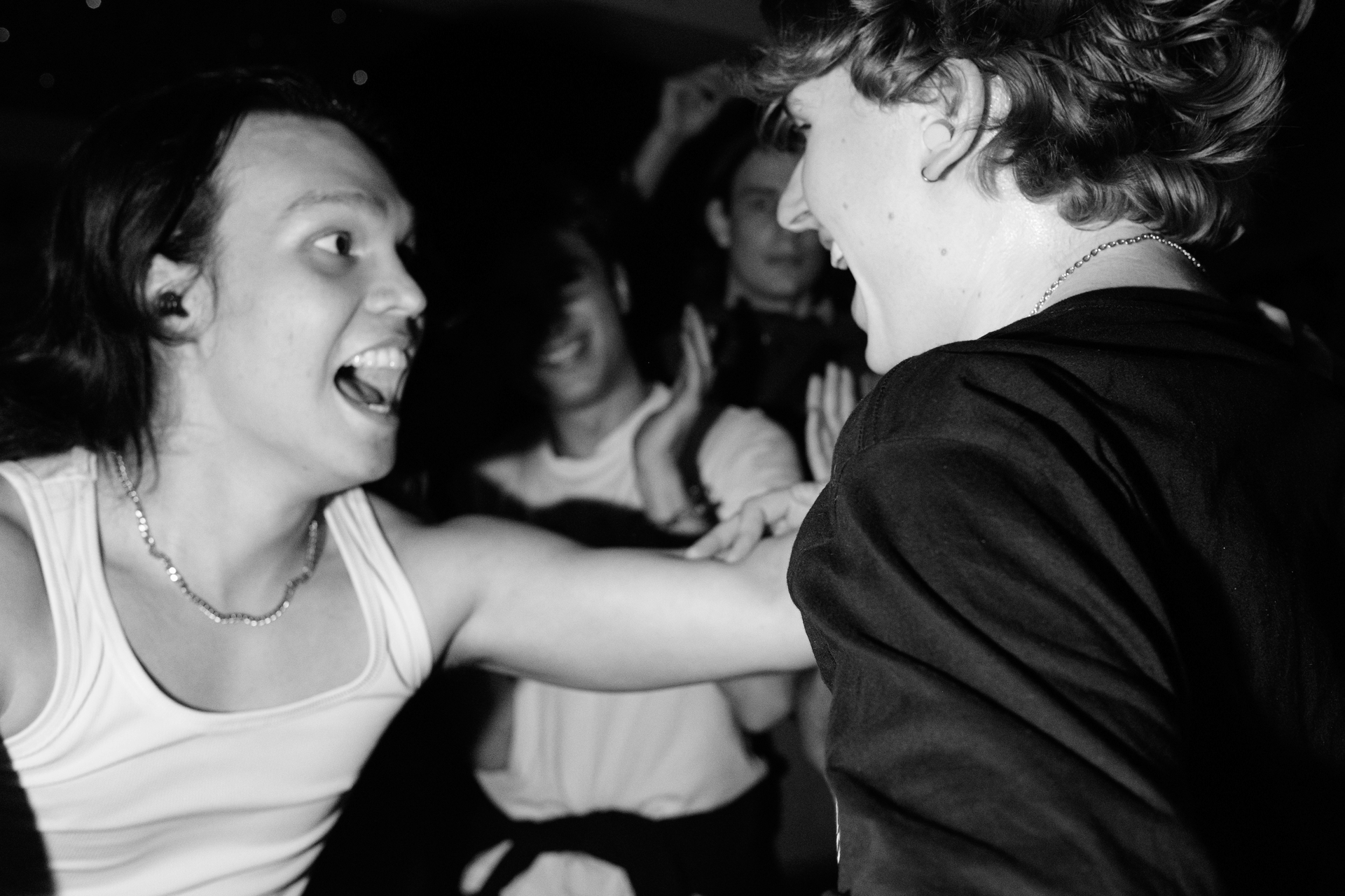 Two audience members grabbing eachother and dancing.