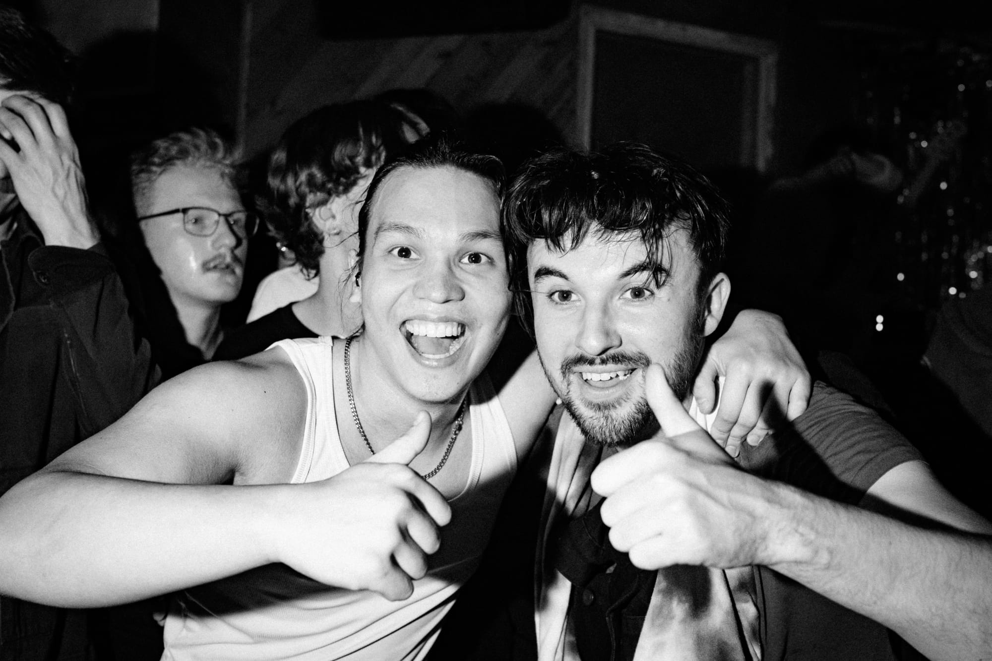 Two people with their thumbs up.