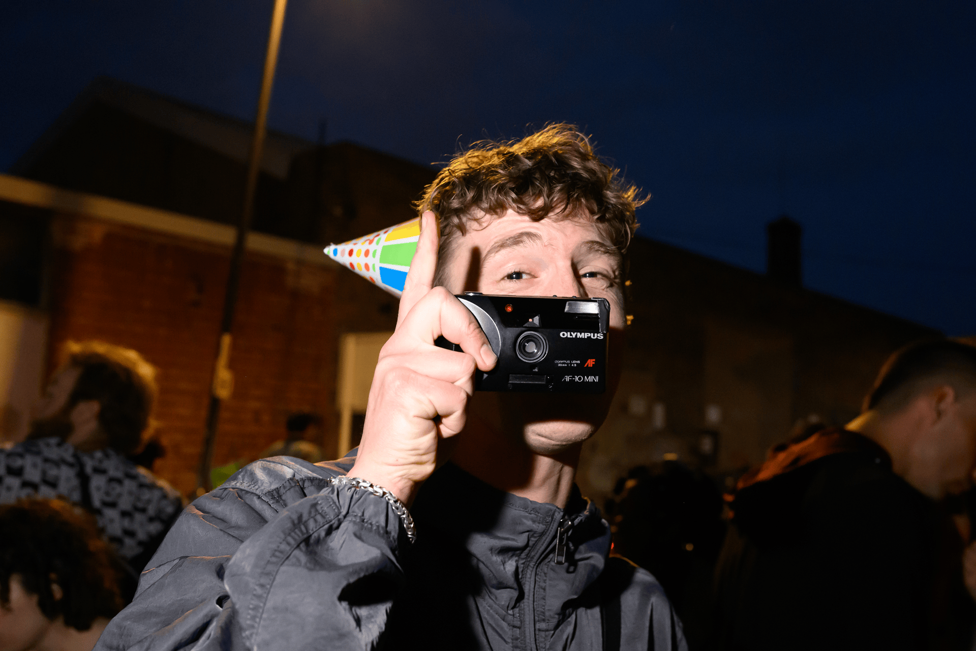 Someone taking a picture with a party hat on.