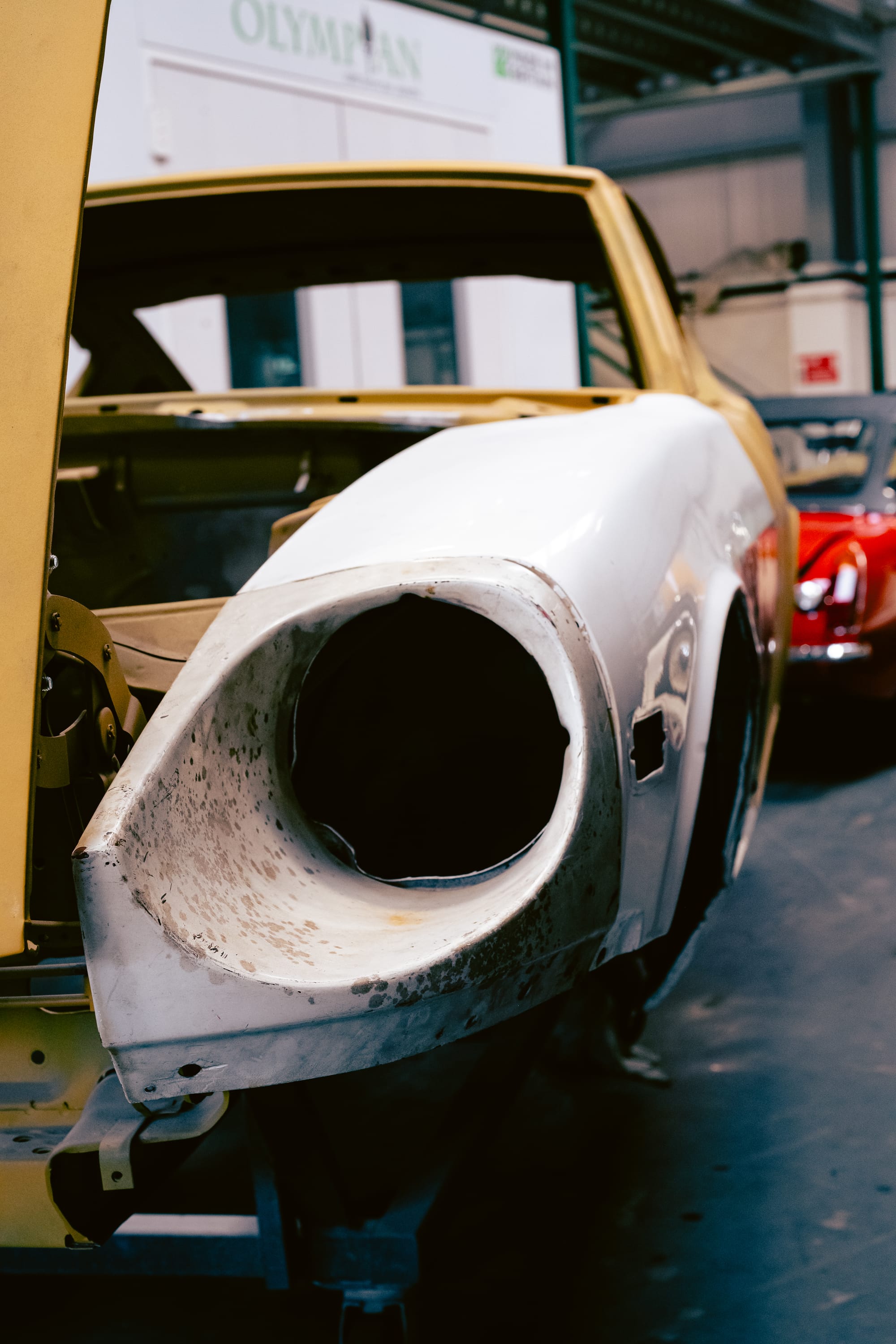A close up of the empty headlight of a Datsun 240Z.