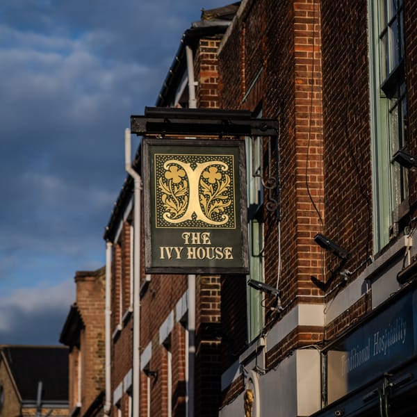 A tavern sign for The Ivy House.