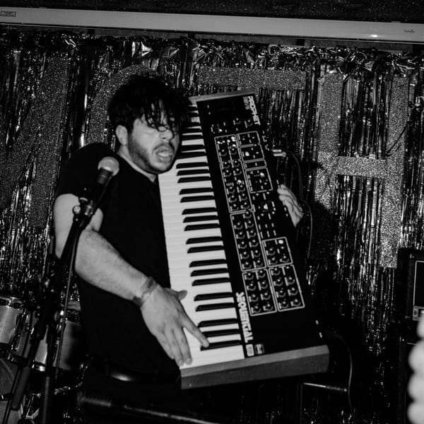 Moe Kazra rocking an improvised keytar by picking up a massive synth.