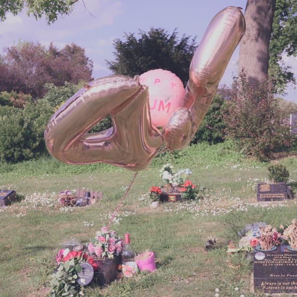 Balloons billowing over a grave.