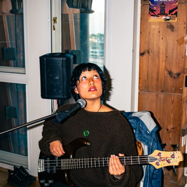 A bassist with bleach brows and a bob.